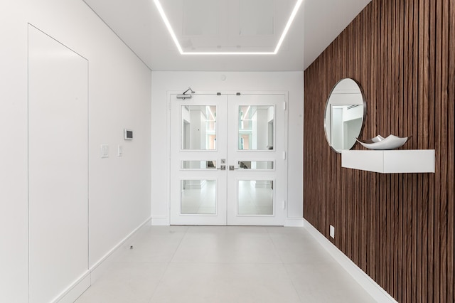 entryway featuring wooden walls and french doors