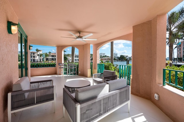 view of patio / terrace featuring an outdoor hangout area, ceiling fan, and a water view