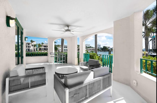 view of patio / terrace featuring an outdoor hangout area, ceiling fan, and a water view