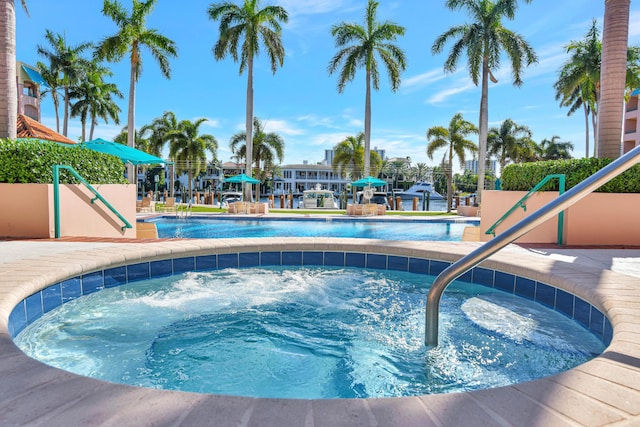 view of swimming pool featuring a hot tub