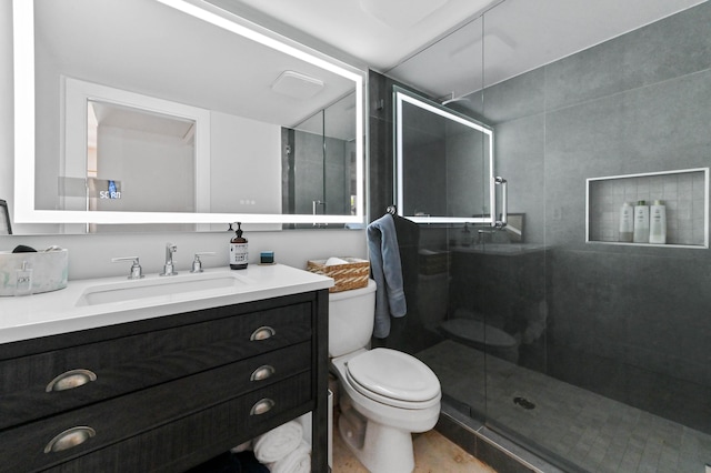 bathroom with a shower with door, vanity, and toilet