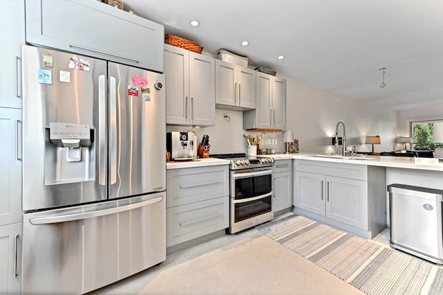 kitchen with stainless steel appliances, gray cabinets, and sink