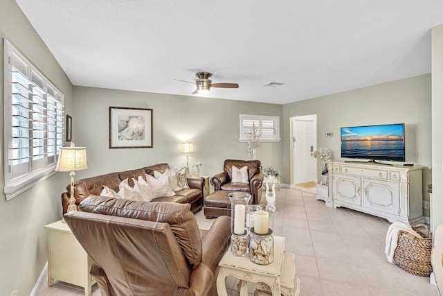 tiled living room featuring ceiling fan