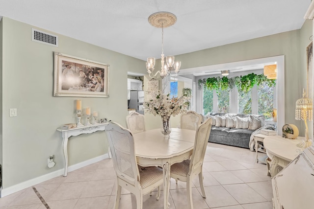 dining area featuring visible vents, a notable chandelier, baseboards, and light tile patterned floors