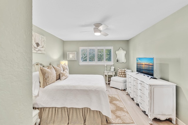 bedroom with ceiling fan and light wood-type flooring