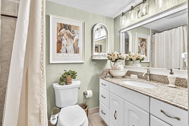 bathroom featuring toilet, a textured ceiling, vanity, curtained shower, and tile patterned flooring