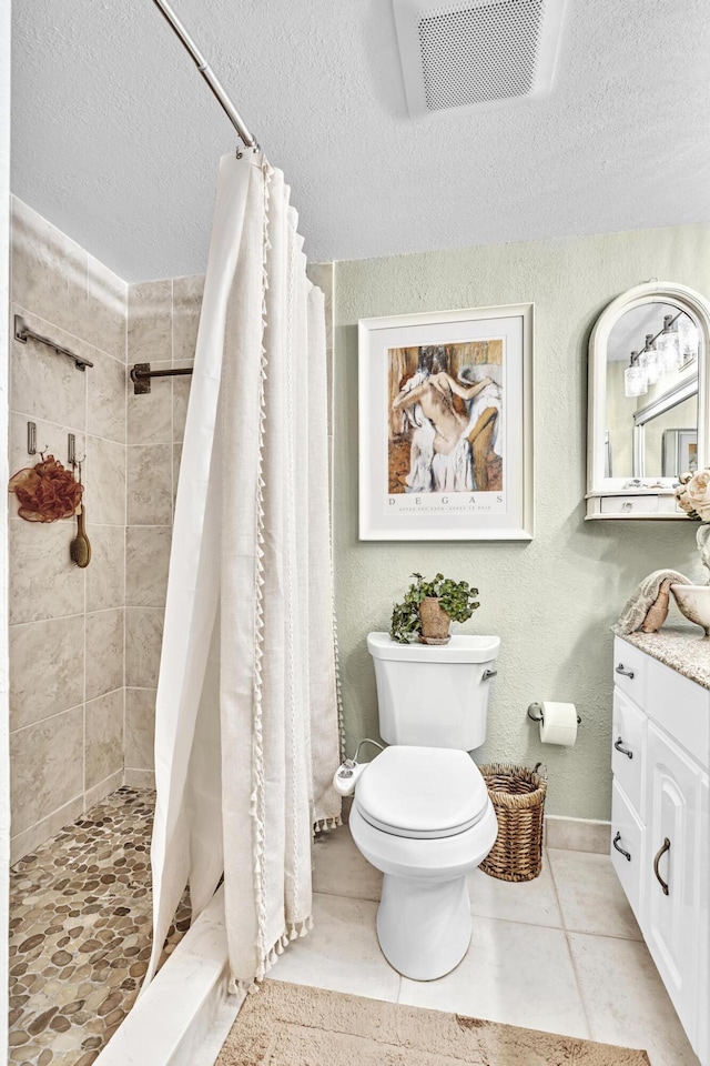 bathroom with vanity, a textured ceiling, a shower with curtain, tile patterned floors, and toilet