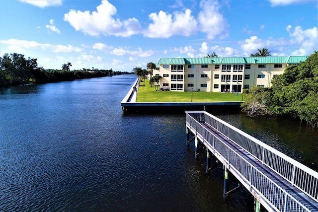 view of dock featuring a water view and a lawn