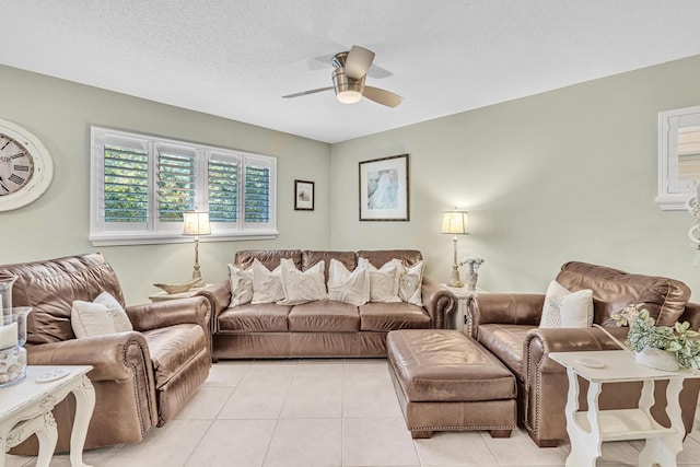 living room featuring light tile patterned floors, a textured ceiling, and ceiling fan