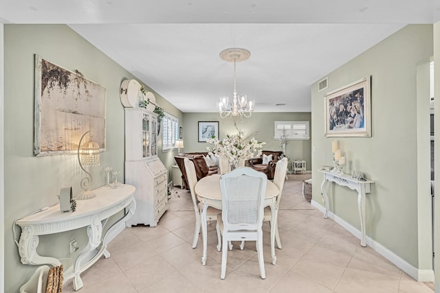 dining space featuring light tile patterned floors and a notable chandelier