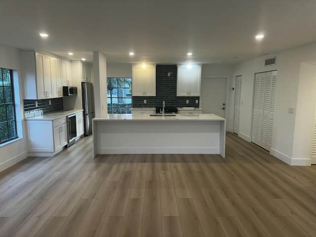 kitchen with white cabinetry, an island with sink, appliances with stainless steel finishes, and sink