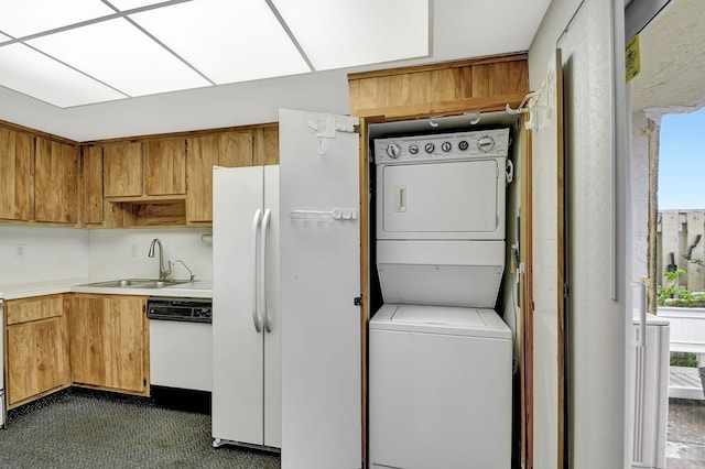 interior space featuring sink and stacked washer and clothes dryer