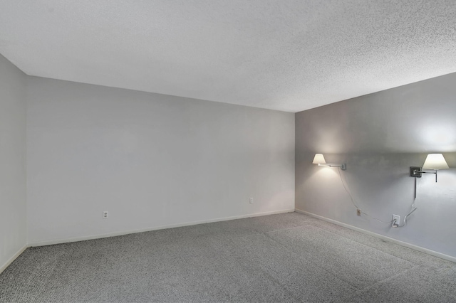 unfurnished room featuring carpet floors and a textured ceiling