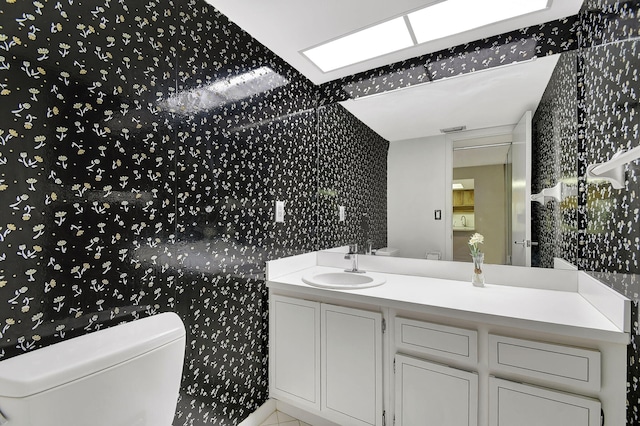 bathroom with vanity, toilet, and tile patterned flooring