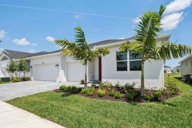 ranch-style home with a garage, stucco siding, decorative driveway, and a front yard