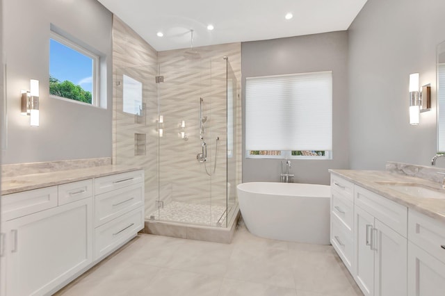 bathroom with vanity and shower with separate bathtub