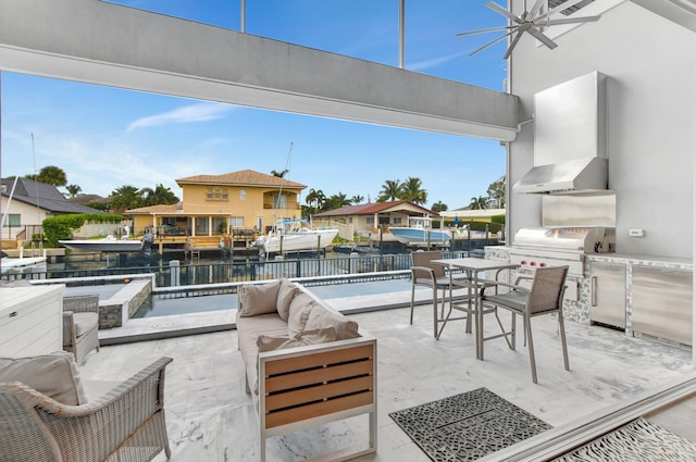 view of patio featuring ceiling fan, a water view, an outdoor living space, a pool with hot tub, and exterior kitchen