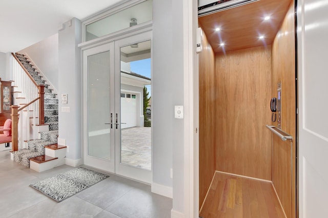 entryway featuring elevator and french doors