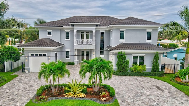 view of front of property featuring a garage and a balcony