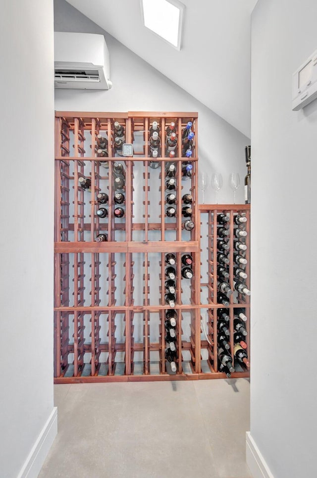 wine cellar featuring a wall mounted AC and vaulted ceiling