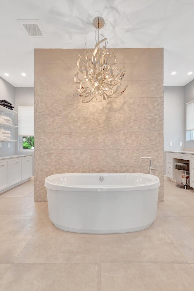 bathroom featuring vanity, a washtub, and tile walls