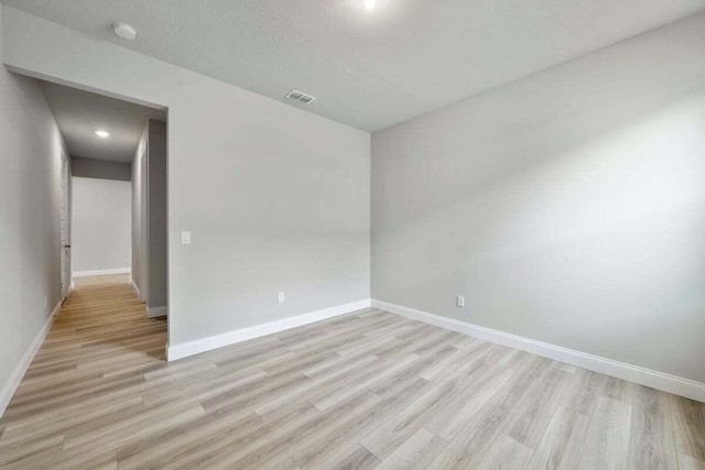 spare room featuring light wood-type flooring