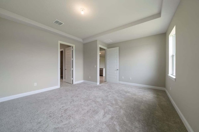 unfurnished room featuring light colored carpet