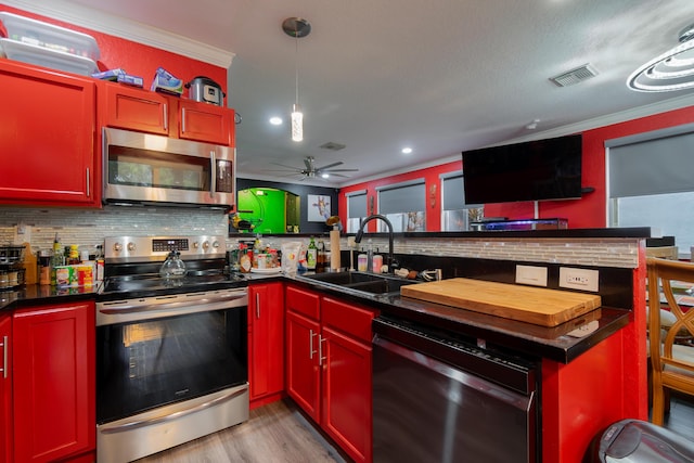 kitchen with appliances with stainless steel finishes, sink, backsplash, ornamental molding, and light hardwood / wood-style flooring