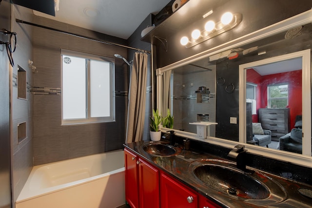 bathroom with double vanity, shower / tub combo, and a sink