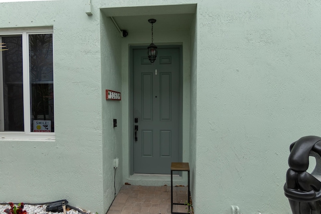 property entrance with stucco siding