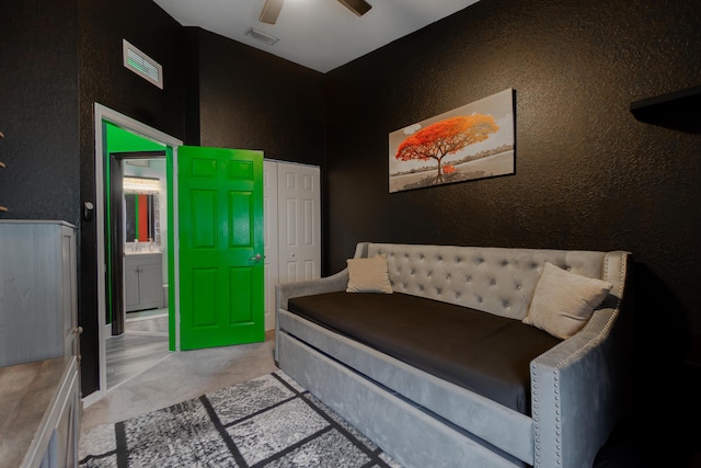 bedroom featuring ceiling fan, connected bathroom, light carpet, visible vents, and a closet