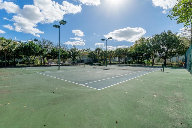 view of sport court featuring fence