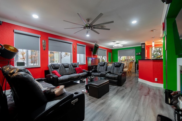 interior space with ceiling fan, ornamental molding, and light hardwood / wood-style flooring