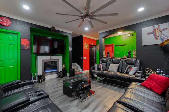 living room featuring crown molding, ceiling fan, and wood-type flooring