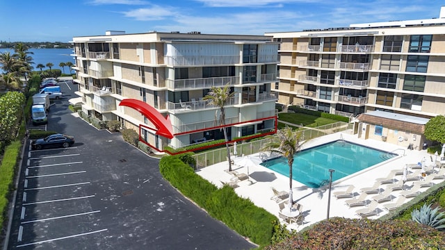 view of pool with a water view and a patio area