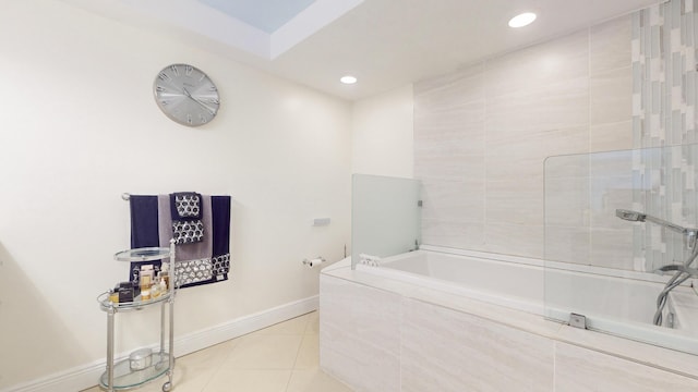 bathroom featuring a relaxing tiled tub and tile patterned floors