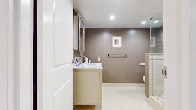 bathroom with vanity, toilet, tile patterned floors, and walk in shower