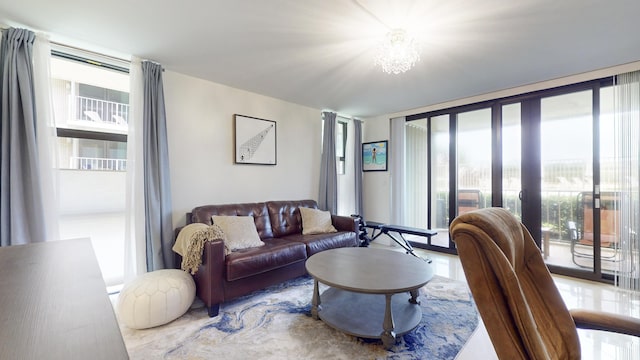 living room with a wall of windows, a healthy amount of sunlight, and a chandelier