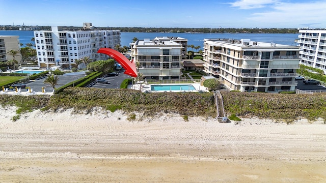 bird's eye view with a water view and a view of the beach