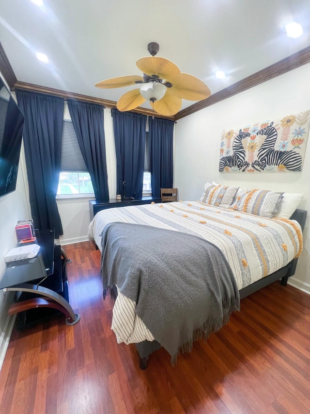 bedroom featuring ornamental molding, dark hardwood / wood-style floors, and ceiling fan