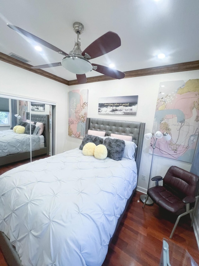 bedroom featuring dark hardwood / wood-style flooring, ornamental molding, and ceiling fan