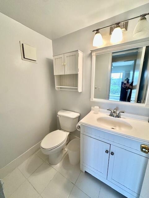 bathroom featuring vanity, tile patterned flooring, and toilet