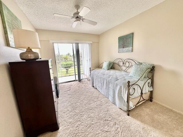 bedroom with ceiling fan, light carpet, a textured ceiling, and access to outside