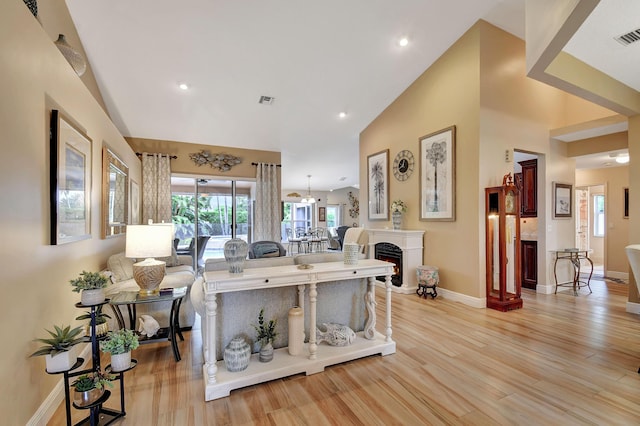 living room with vaulted ceiling and light hardwood / wood-style floors