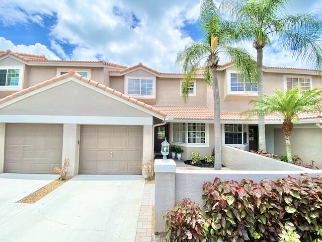 mediterranean / spanish-style home with a garage