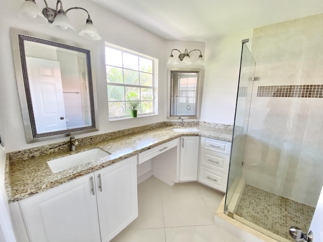 bathroom featuring tile patterned flooring, vanity, and a shower with shower door