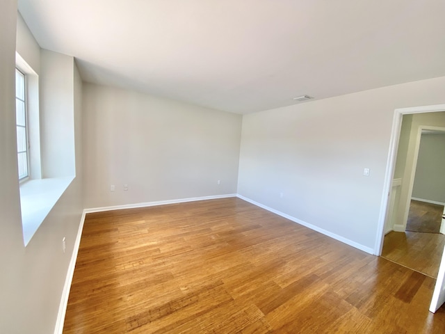 unfurnished room featuring light hardwood / wood-style floors