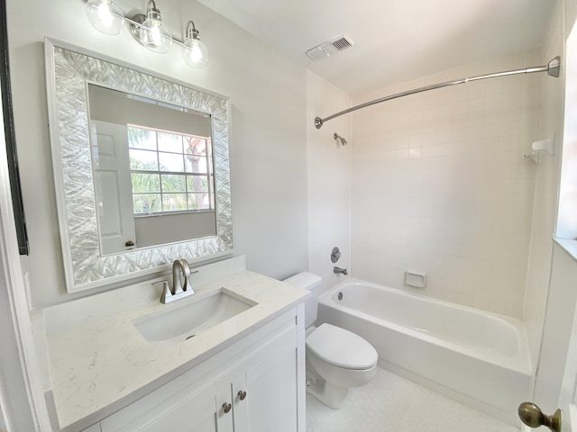 full bathroom with vanity, tiled shower / bath combo, and toilet