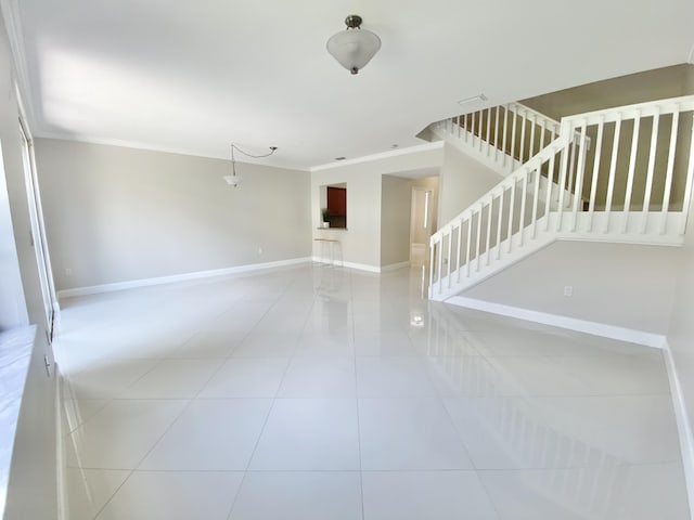 unfurnished room with crown molding and tile patterned floors