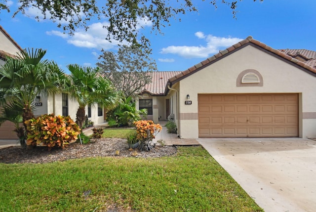 view of front of property with a garage and a front yard